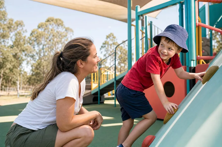 Parent supporting a child at an all-abilities playground in Fairfield