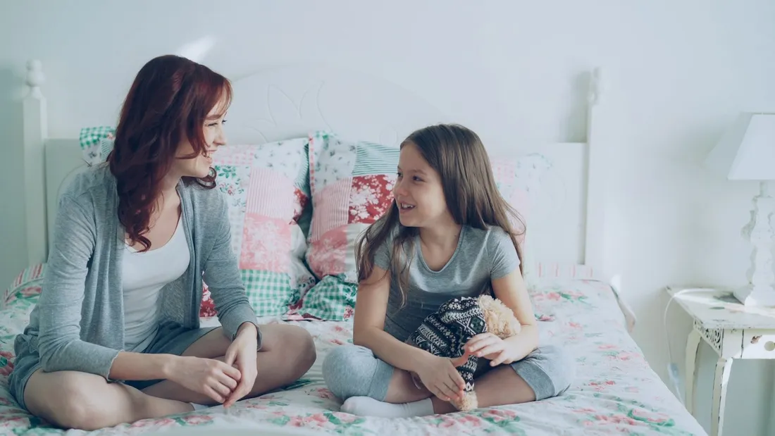 A parent and child talking warmly at home during a functional behaviour assessment