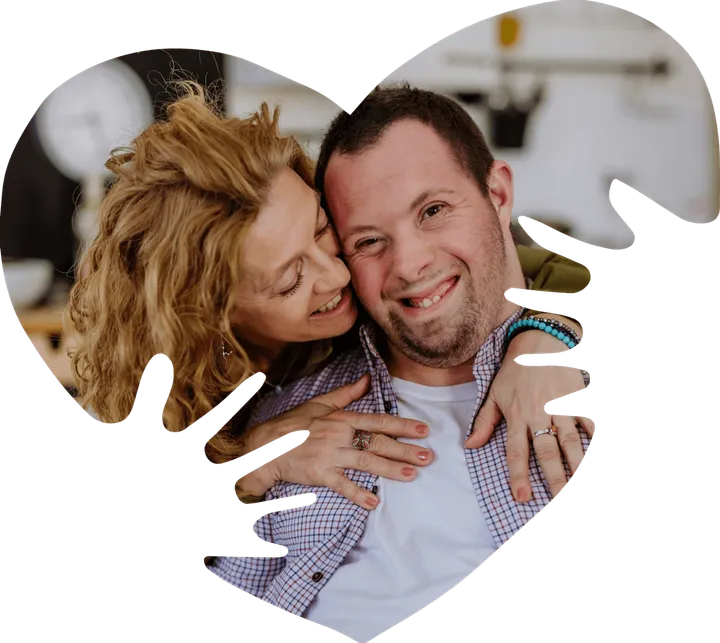 A mum hugging her adult son, framed in the My Behaviour Support heart